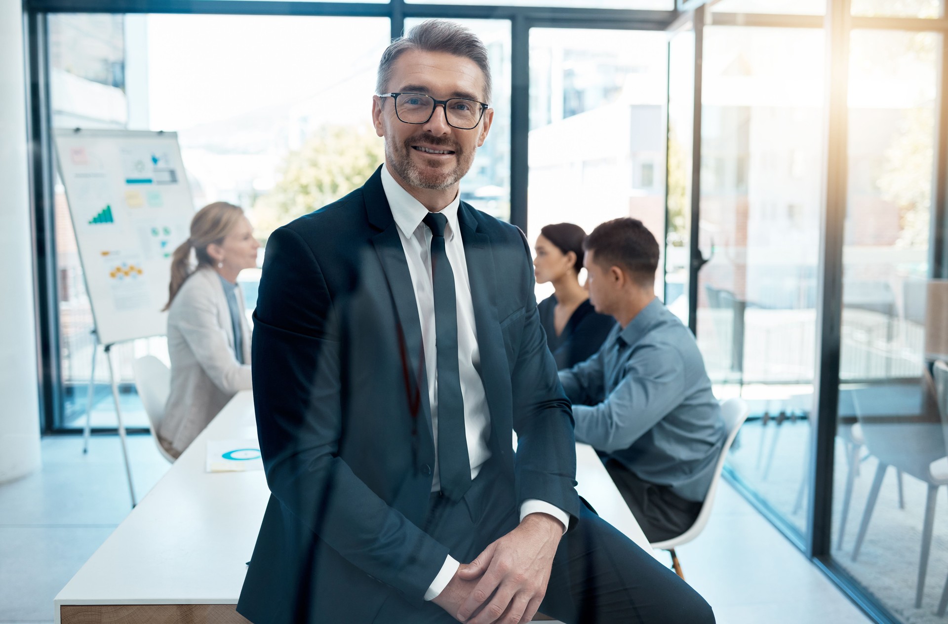 Leader, CEO and manager in a boardroom meeting with his team for planning, strategy and planning future growth. Business, marketing and leadership with a mature male employee or mentor in an office